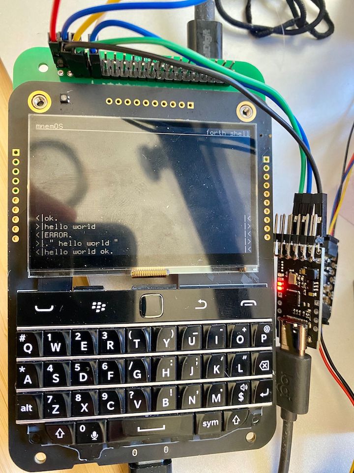A picture of a SQFMI Beepy, a device with a blackberry keyboard and monochrome screen, showing a forth shell